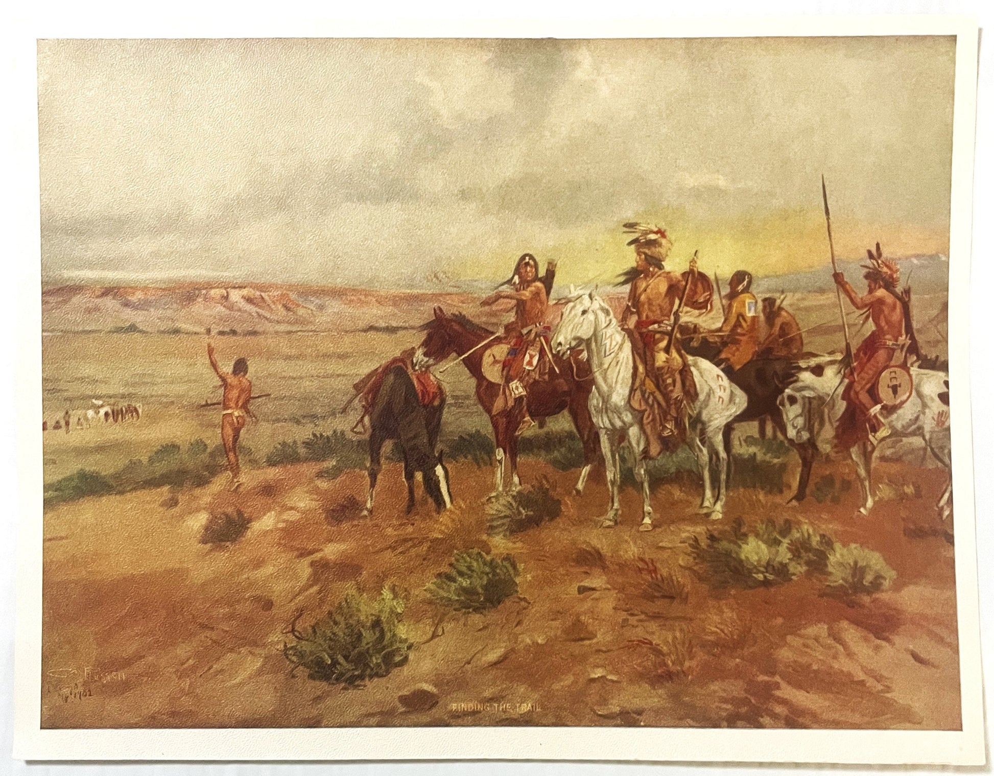 Vintage art print depicting Native American riders on horseback in desert landscape, titled "Finding the T