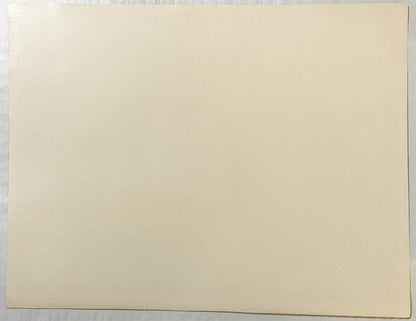 Blank cream-colored page or backing of a vintage art print, shown flat against gray surface