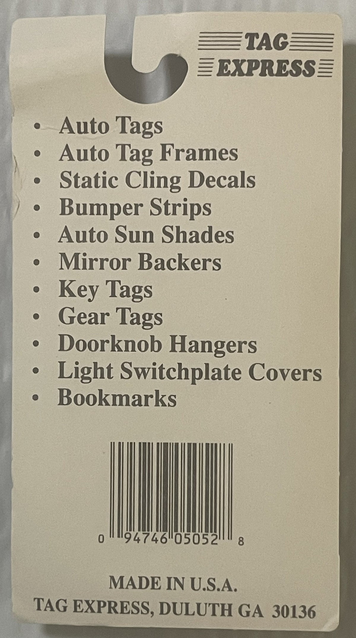 Cream-colored Tag Express product card listing auto accessories and merchandise, with barcode and Duluth, GA address visible