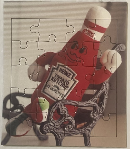 Vintage Heinz Tomato Ketchup 20-piece jigsaw puzzle featuring red condiment bottle mascot with white chef's hat sitting in or