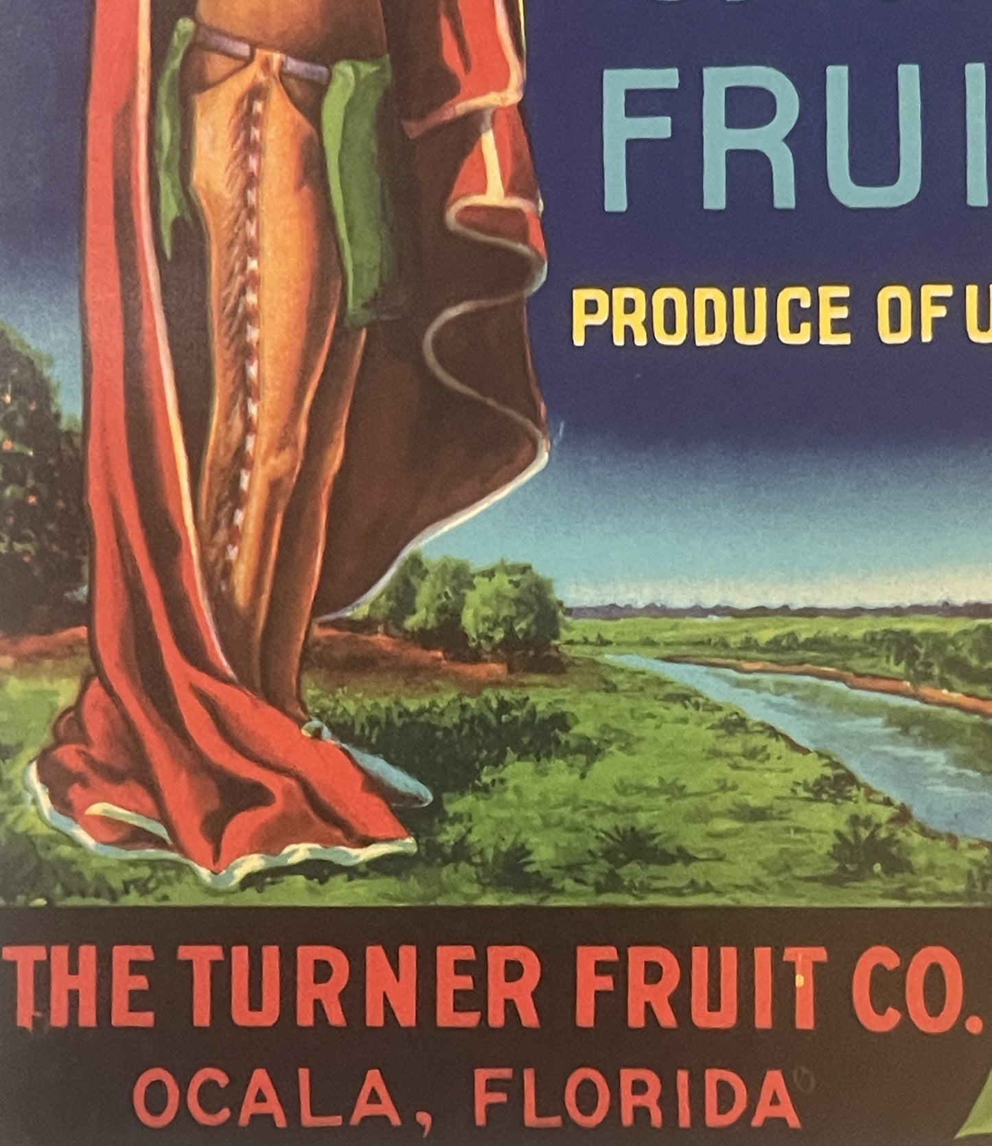 Vintage citrus crate label featuring a Native American figure playing a flute in red robes overlooking a green landscape with