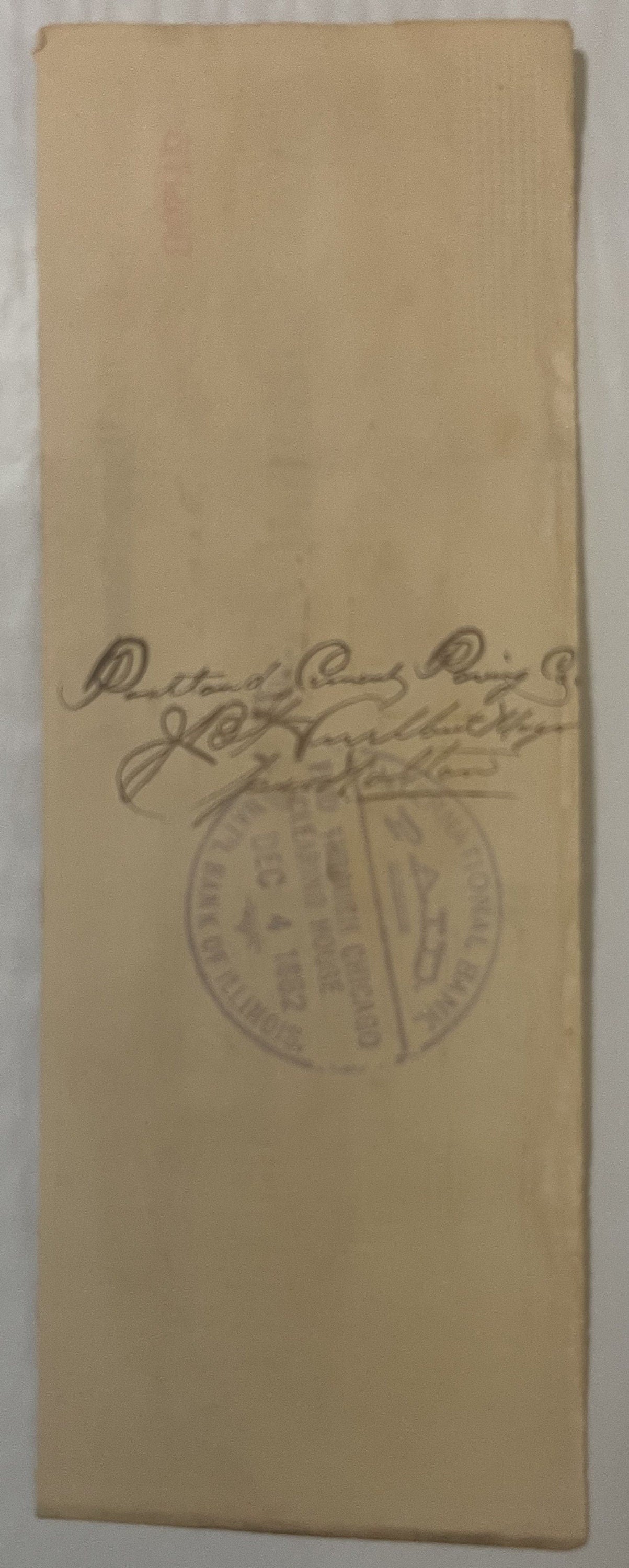 Cream-colored paper check with handwritten signature and circular stamp from Downer and Bemis Brewing Co., Chicago, photograp
