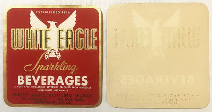 Vintage gold-embossed White Eagle sparkling beverages label from Fall River, showing red front and cream back side