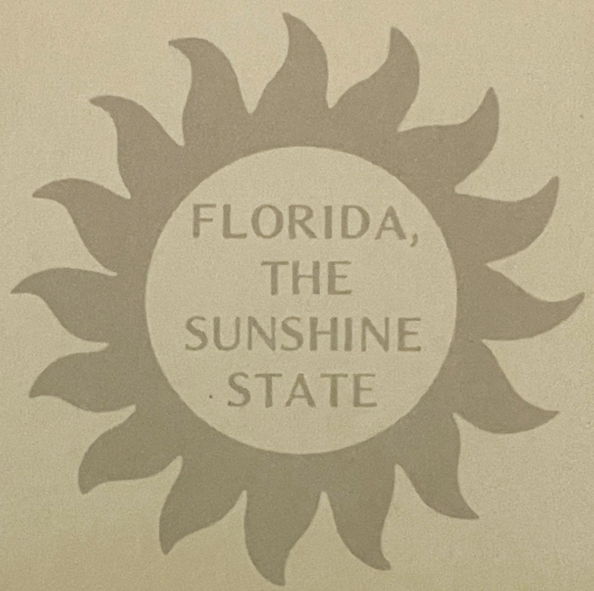 Tan vintage postcard with embossed sunflower design surrounding circular center text reading "FLORIDA, THE SUNSHINE STATE