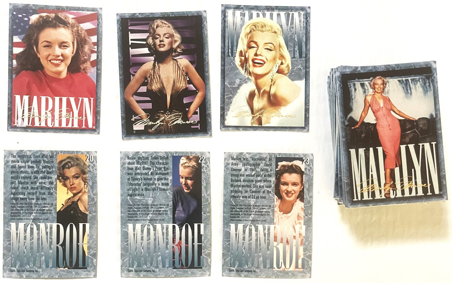 Vintage Marilyn Monroe trading cards displayed in a fan arrangement showing four top cards and three numbered cards (20-23) w