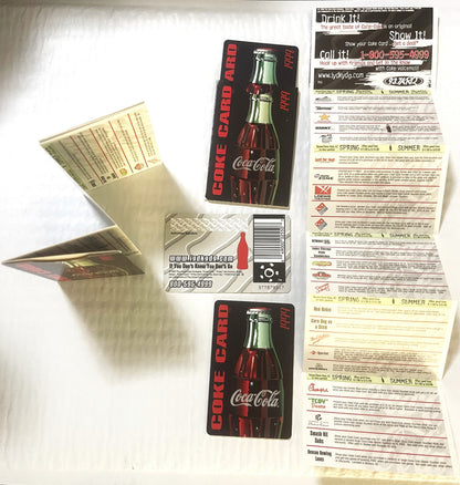 Vintage Coca-Cola promotional credit card with two bottle designs and accordion-fold coupon sheet displayed flat on white sur