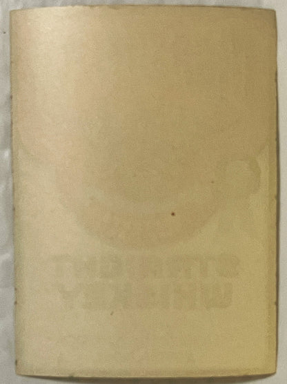 Blank cream-colored vintage whiskey label with aged patina and minor discoloration, photographed flat against light