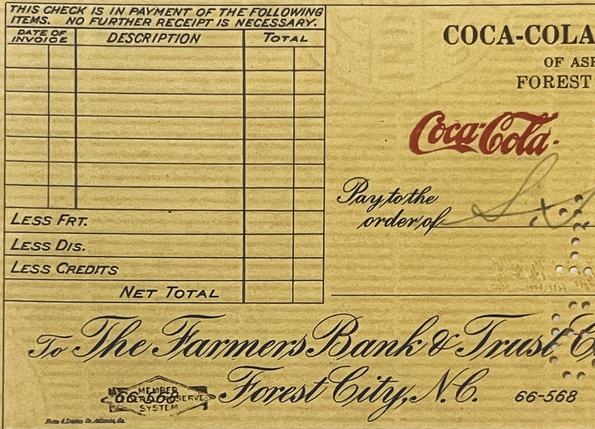 Vintage Coca-Cola bank check from Forest City, NC with blank line items, handwritten signature, and Federal Reserve System st