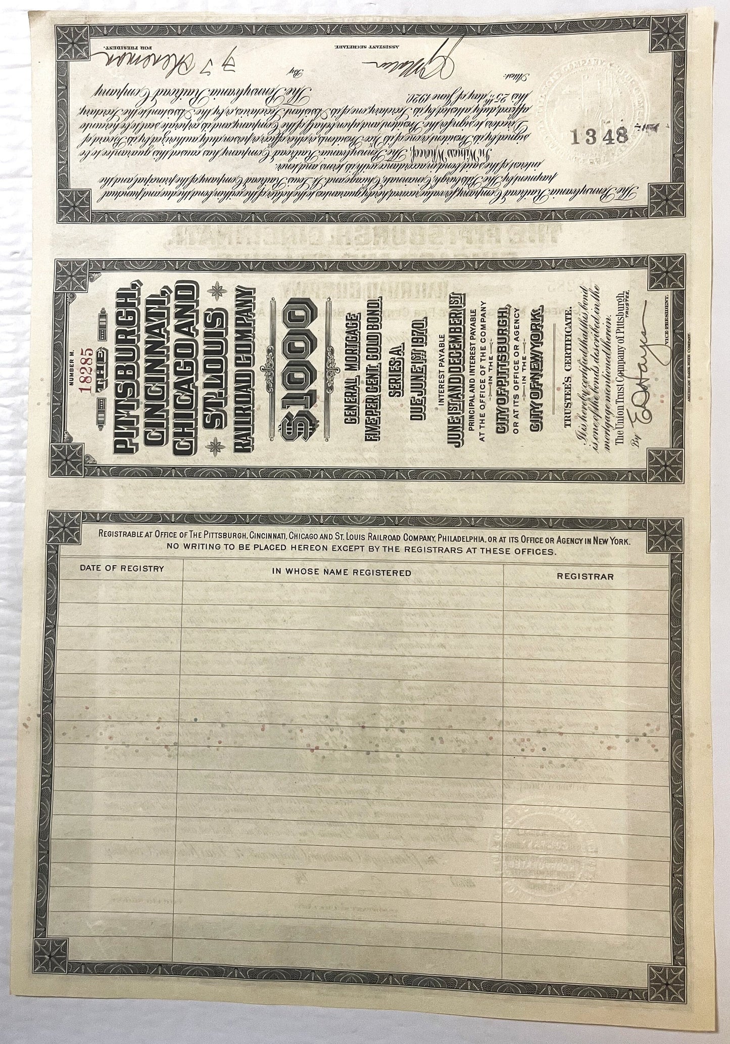 Three-page antique railroad bond certificate from 1920s showing ornate borders, handwritten script text, $1000 denomination h
