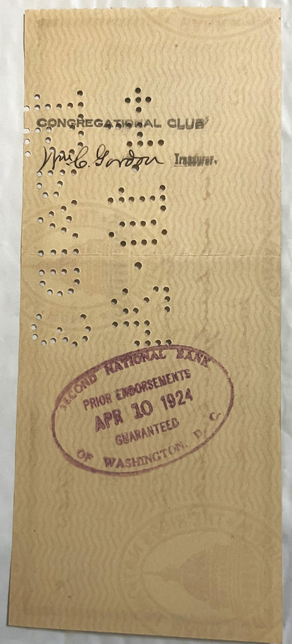 Back of a later Riggs National Bank check on wavy safety-tint paper with a hand-signed endorsement, an oval bank clearing stamp and punch-cancellation holes