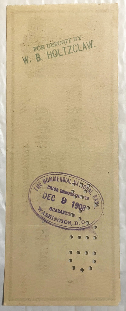 Back of an antique Riggs National Bank check with a rubber-stamped deposit endorsement, an oval bank clearing stamp and punch-cancellation holes