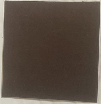 Dark brown square refrigerator magnet photographed flat against white background, appears blank or unmarked on visible side