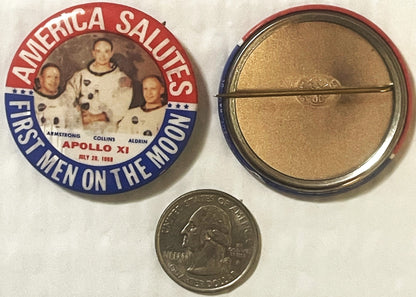 The button front and back with a US quarter placed beside them for scale; the button is roughly twice the coin across.