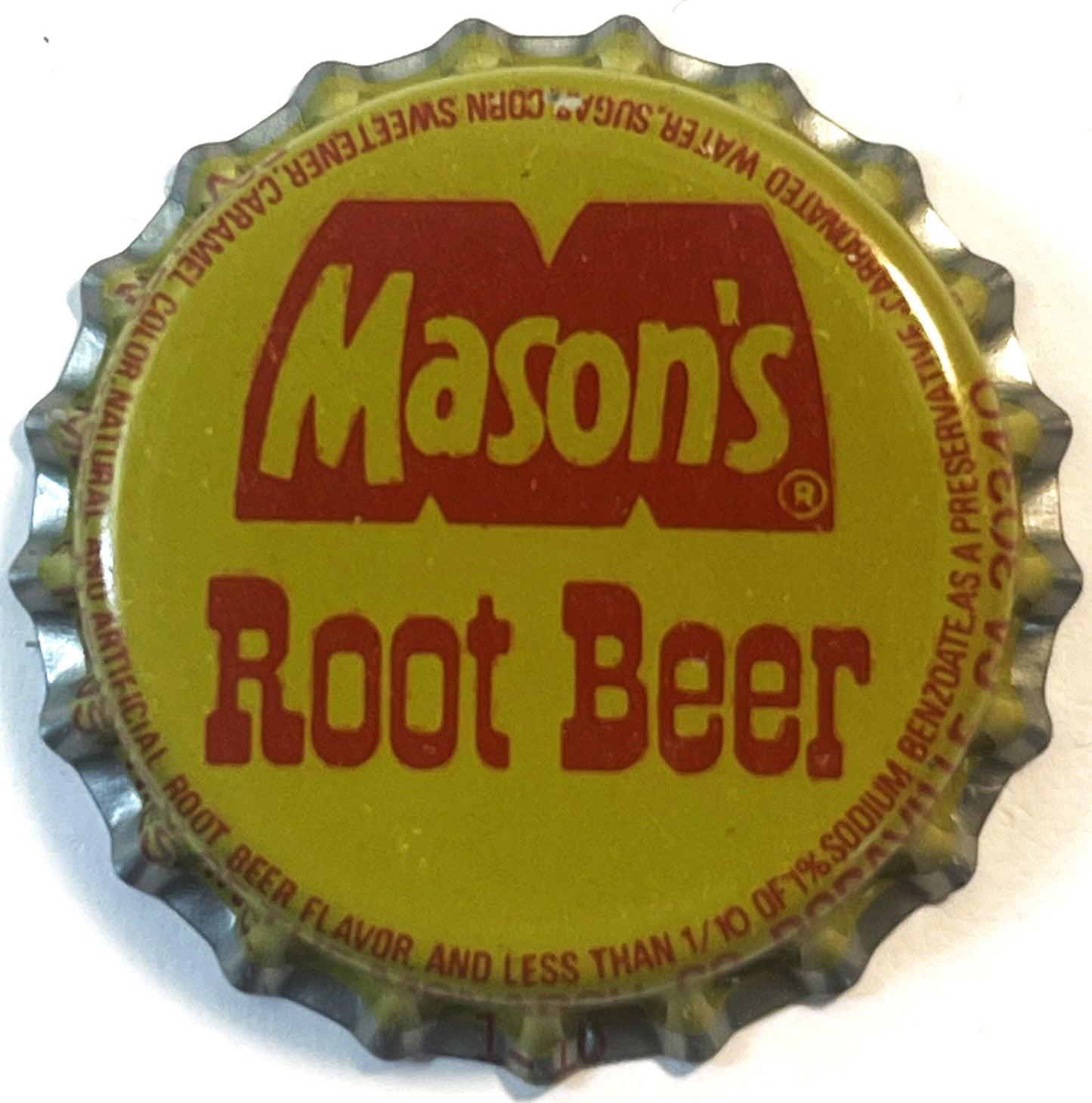 Vintage Mason's Root Beer bottle cap with yellow background and red lettering, shown flat against white surface