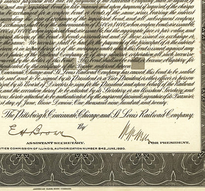 Close-up of 1920 railroad bond certificate showing ornate text, signatures, and decorative border in sepia tones