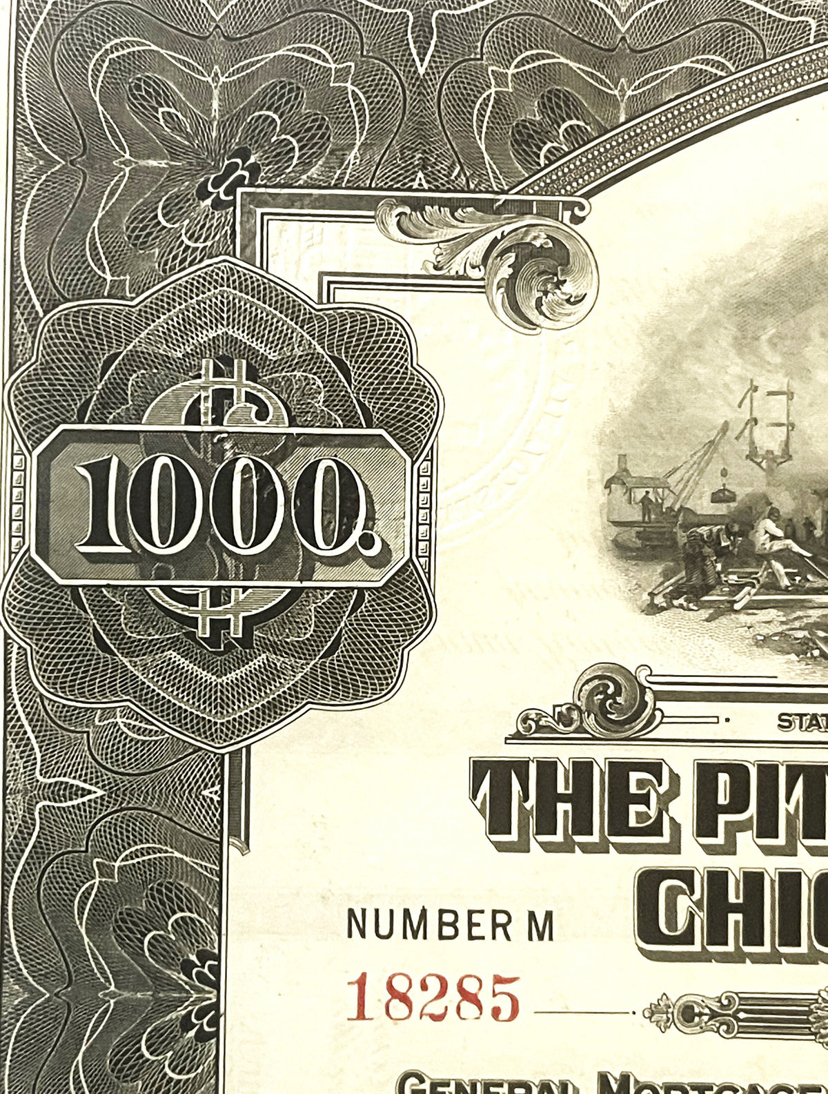 Close-up of ornate left corner of 1000 dollar gold bond certificate with intricate floral engraving, decorative flourishes, a