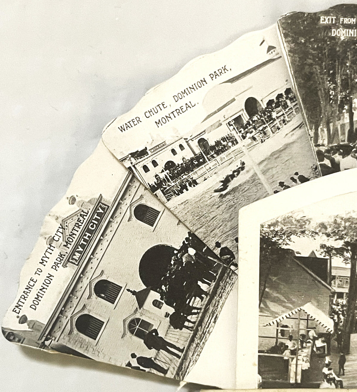 Black and white vintage postcard collection showing boats and attractions at Dominion Park Montreal, fanned display with visi