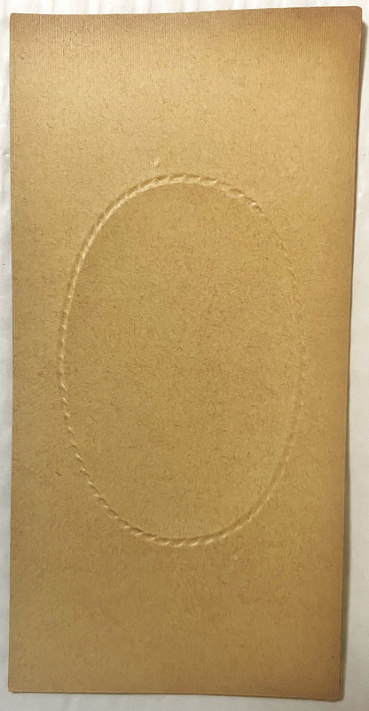 Tan cardboard box insert with embossed oval frame, photographed flat against white background