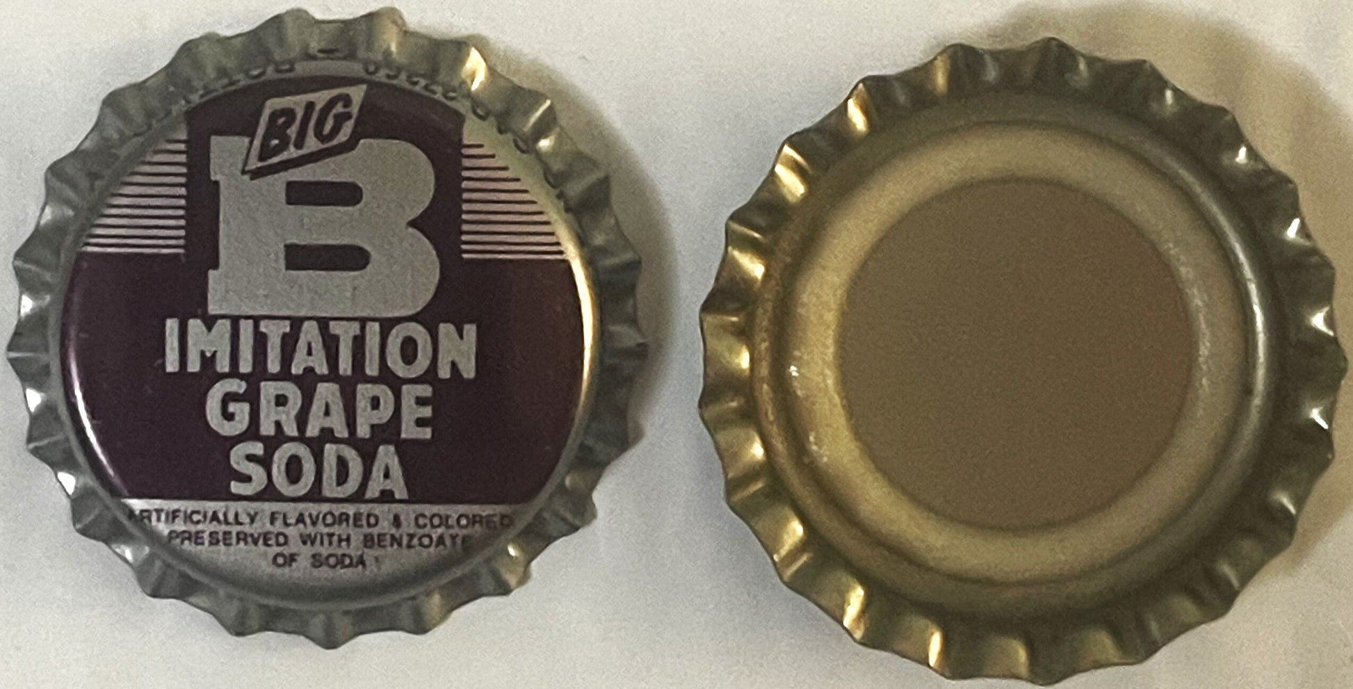 Vintage bottle cap showing front and back views; front displays "BIG B" logo with "IMITATION GRAPE SODA" text on dark backgro