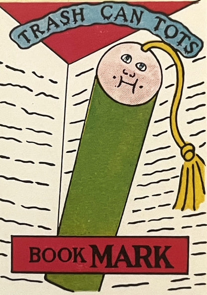 Vintage book mark sticker featuring a smiling wrapped character with green blanket, gold tassel, and "Trash Can Tots" banner 