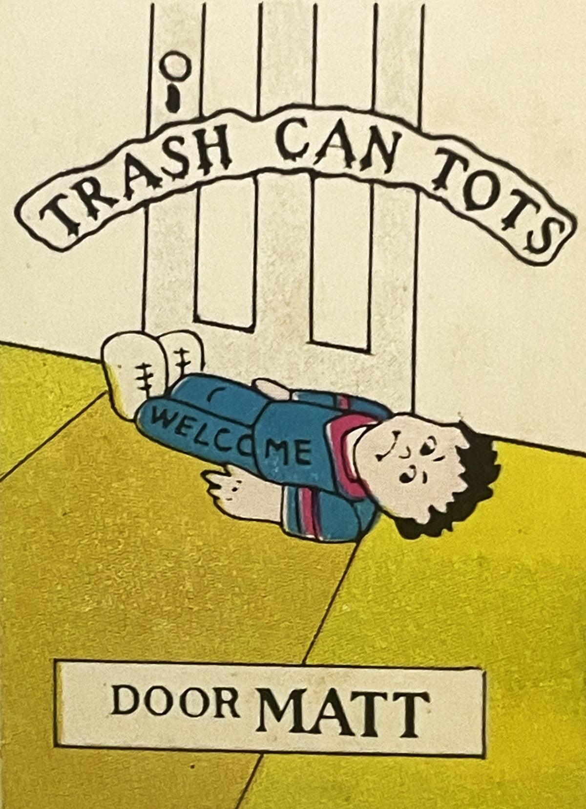 Vintage sticker showing cartoon character labeled "Door Matt" lying on yellow ground before "Trash Can Tots" storefront, colo