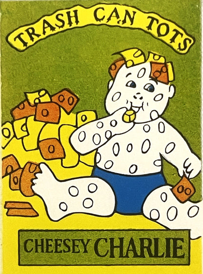 Vintage sticker featuring a spotted cartoon character named Cheesey Charlie eating crackers, with "Trash Can Tots" banner abo