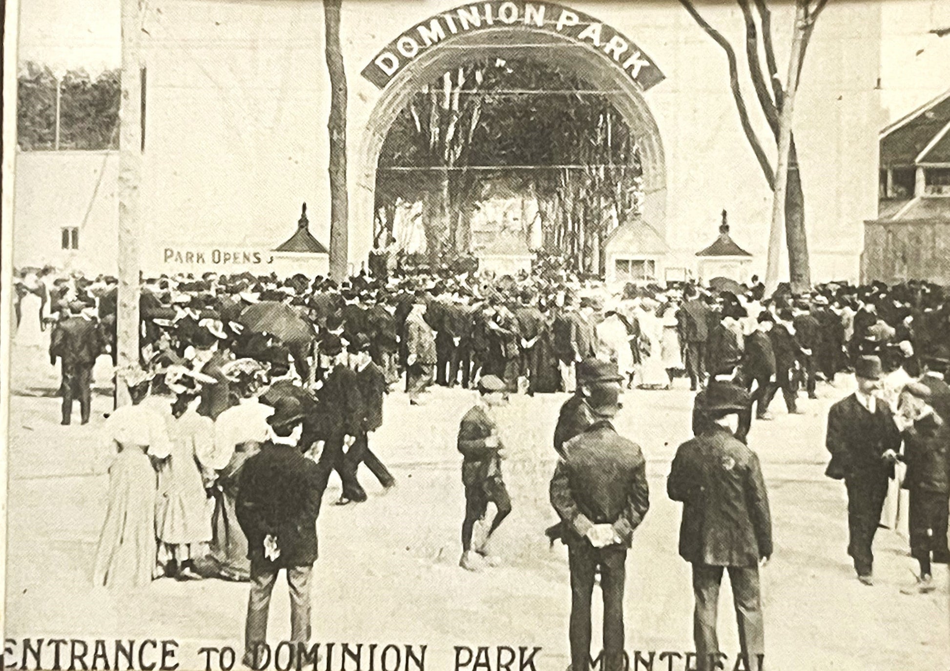 Sepia-toned postcard showing crowds of visitors at Dominion Park entrance in Montreal, with ornate archway and "Park Opens" s
