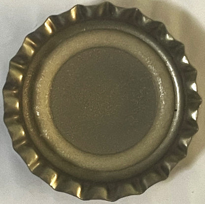 Vintage bottle cap with crimped metal edges and ribbed rim, shown from above on white surface