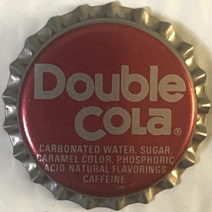 Vintage Double Cola bottle cap with crimped metal edge, deep red center printed with silver text listing carbonated water, su