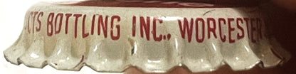 Close-up of a crimped bottle cap showing red text reading "UIS BOTTLING INC., WORCESTER" on cream-colored ridged metal.