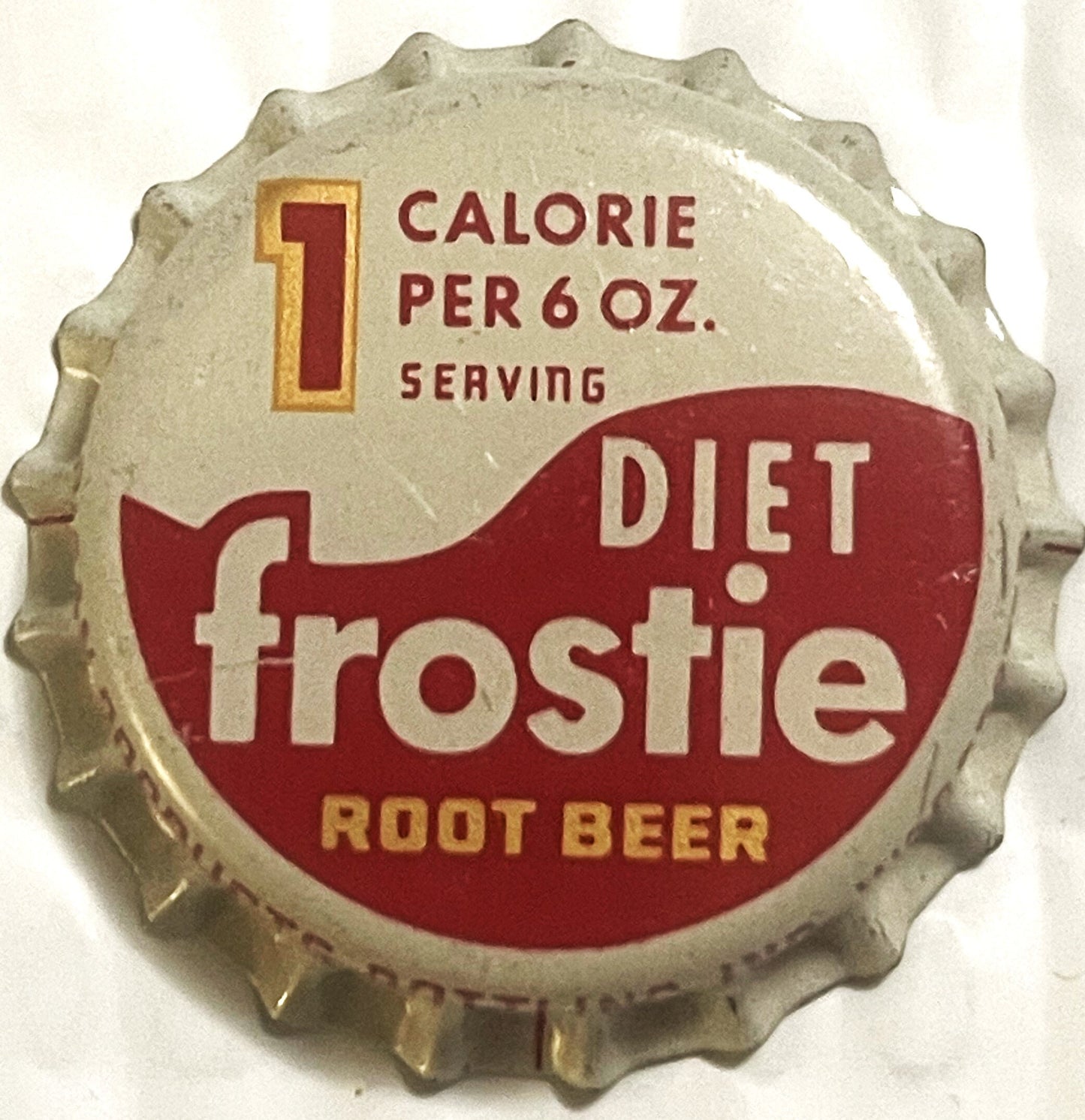 Vintage bottle cap with crimped metal edges, cream and dark red design, printed text reading "Diet Frostie Root Beer" and "1 
