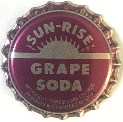 Purple bottle cap with "SUN-RISE GRAPE SODA" text and sun logo, shown flat against white background