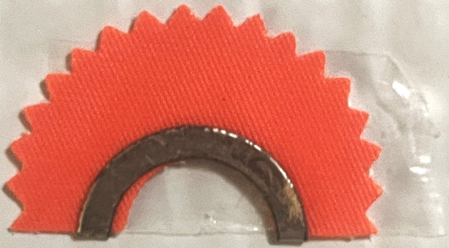 Red fabric star-burst shaped backing with dark metal horseshoe-shaped animal call device mounted on cream background