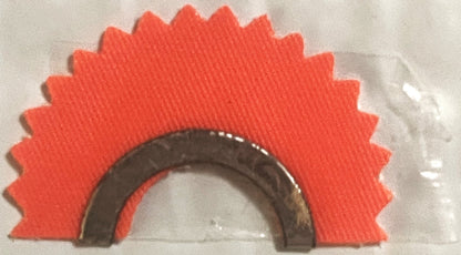 Red fabric star-burst shaped backing with dark metal horseshoe-shaped animal call device mounted on cream background