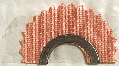 Vintage red brick archway bird call with dark metal curved mouthpiece, displayed against white background