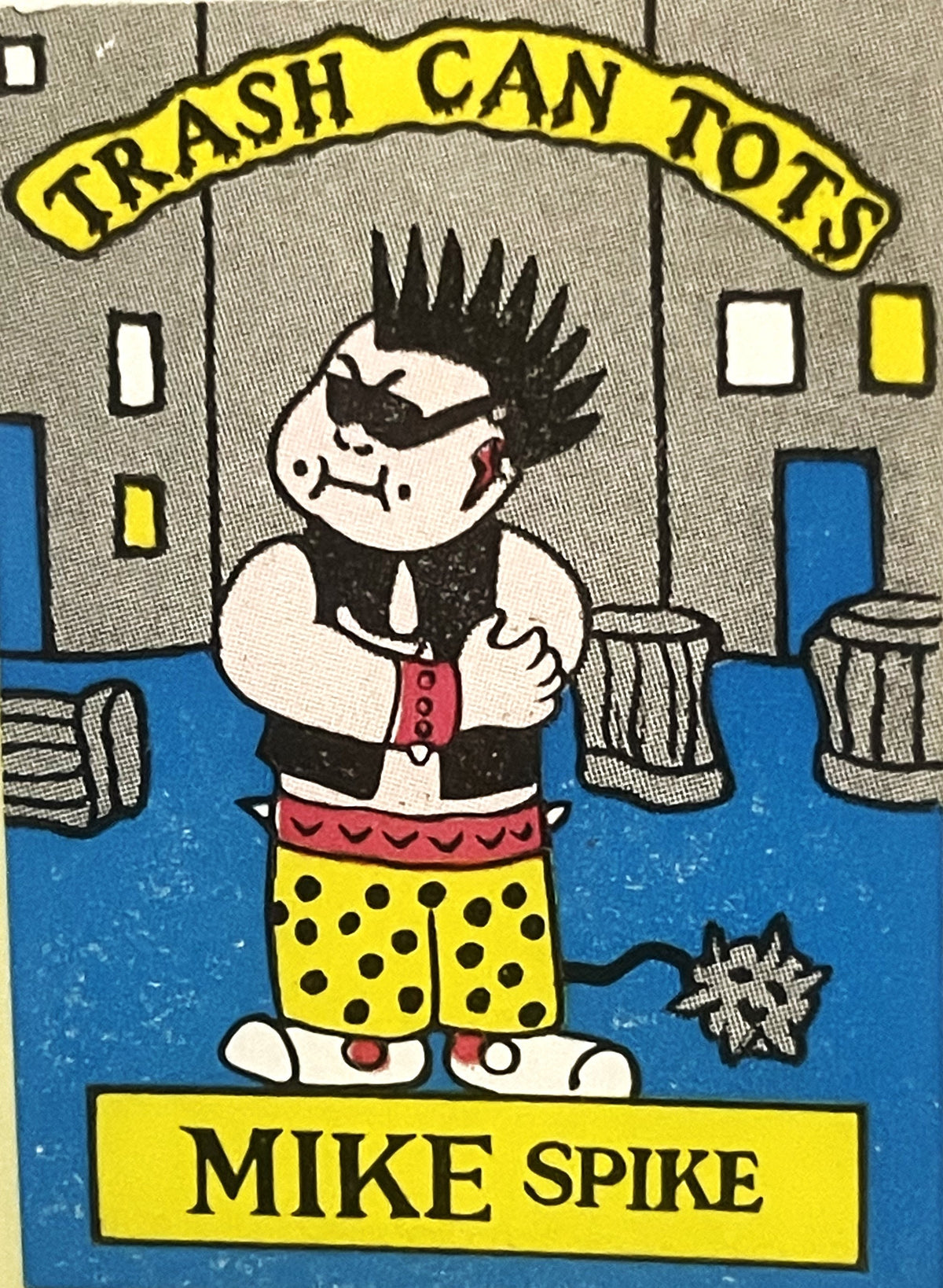 Vintage "Trash Can Tots" sticker featuring Mike Spike character with spiky black hair, eye patch, and yellow polka dot shorts