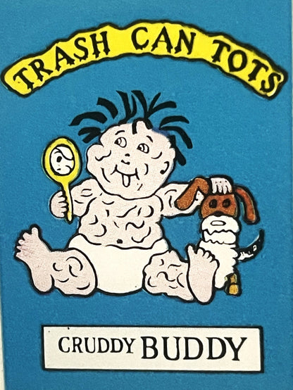 Vintage sticker featuring a messy baby character holding a mirror and spoon next to a brown dog, with "Trash Can Tots" banner