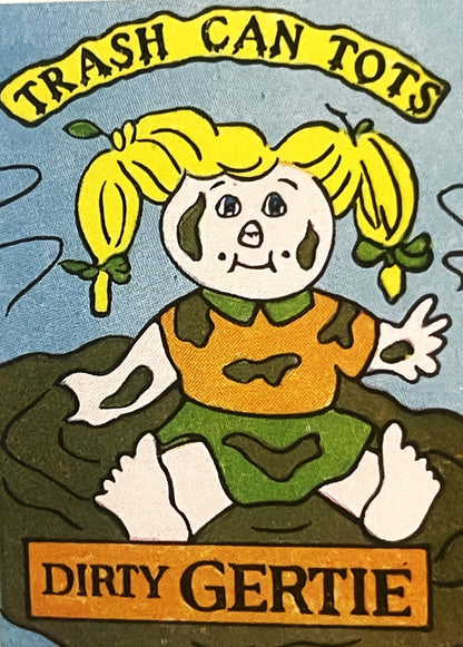 Vintage sticker featuring yellow-haired doll character labeled "Dirty Gertie" sitting in mud, with "Trash Can Tots" banner ab