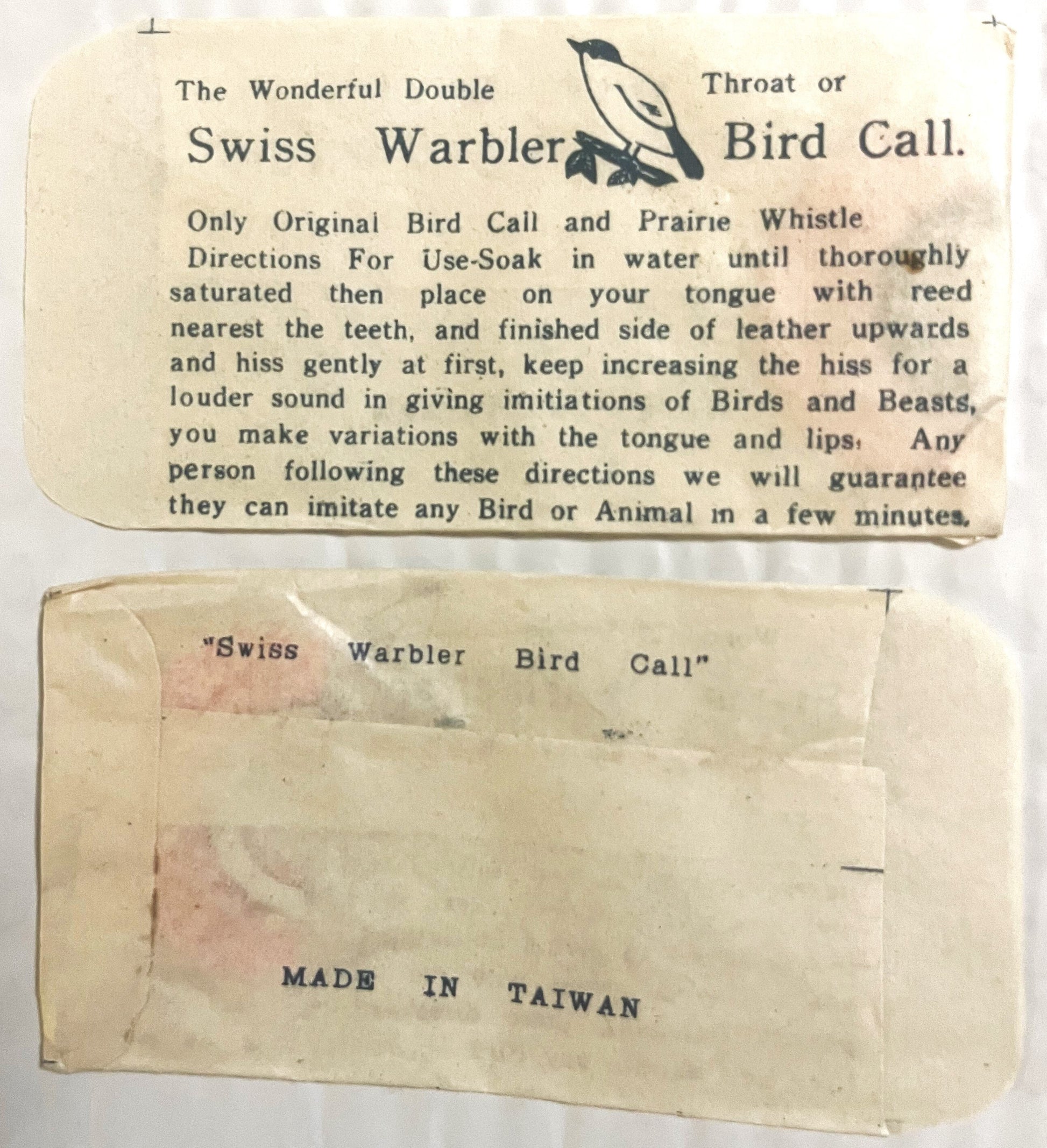 Vintage Swiss Warbler bird call packaging showing instruction card and envelope labeled "Made in Taiwan," cream-colored paper