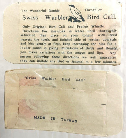 Vintage Swiss Warbler bird call packaging showing instruction card and envelope labeled "Made in Taiwan," cream-colored paper