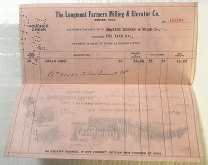 Vintage 1921 pink voucher check from Longmont Farmers Milling & Elevator Co., Denver, with printed fields for description, am