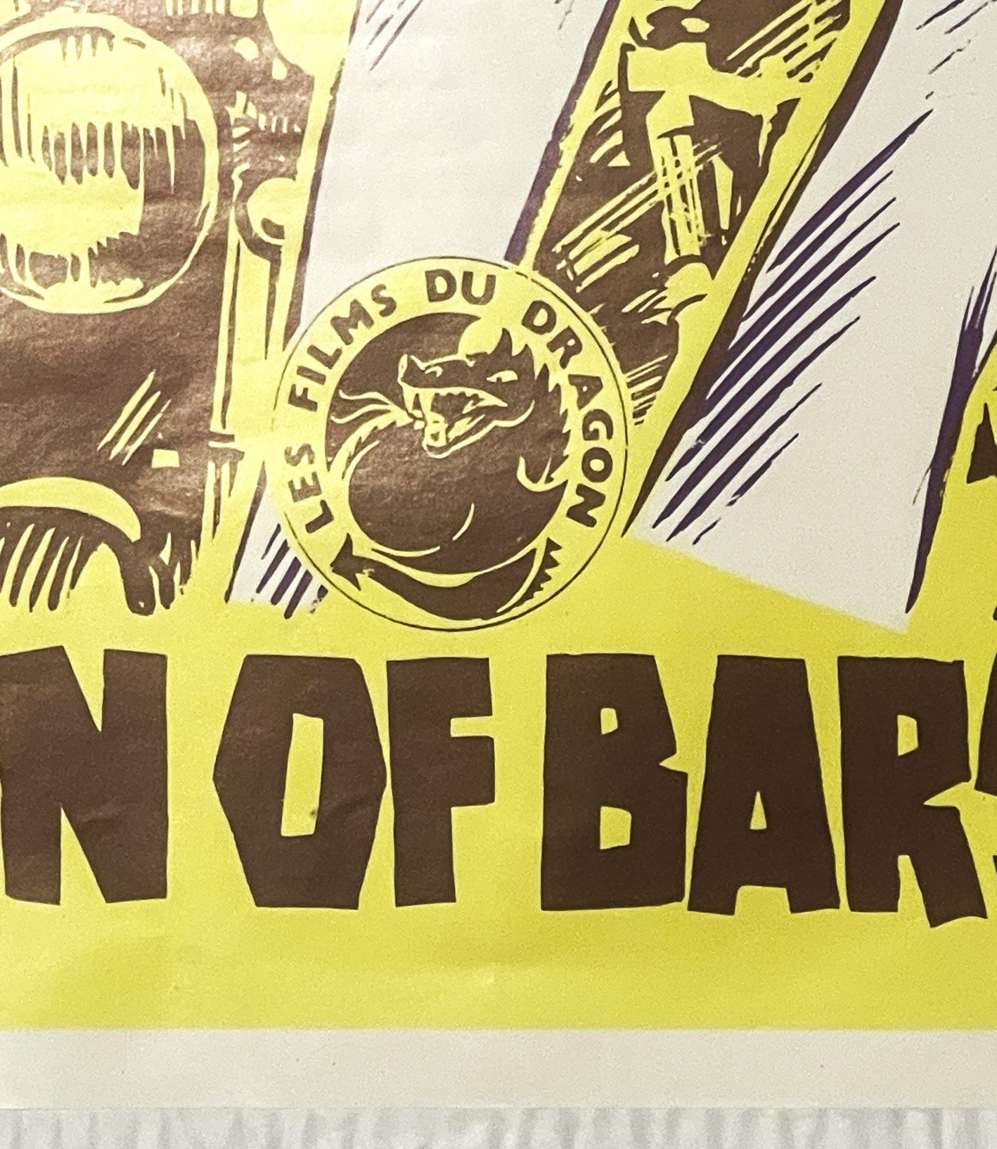 Close-up of vintage movie poster showing yellow and brown colors with "NOFBAR" text visible and circular "Les Films du Orago"