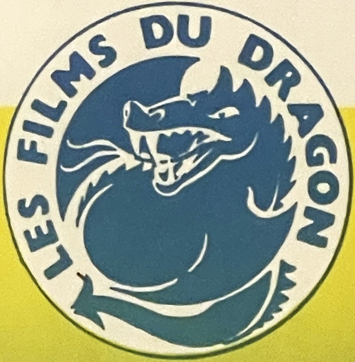Blue LES FILMS DU DRAGON roundel with a coiled, open-jawed dragon, printed on the Triple Cross Belgian movie poster