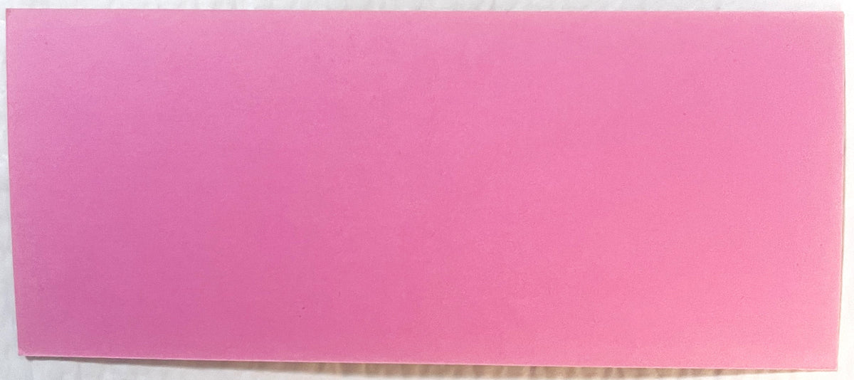 Blank pink ink blotter with slightly worn edges, photographed flat against white background