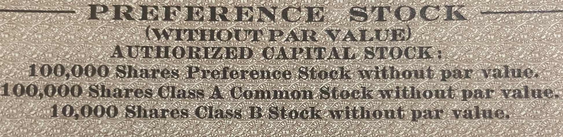 Close-up of embossed text on beige stock certificate showing authorized capital stock details for 100,000 preference shares a