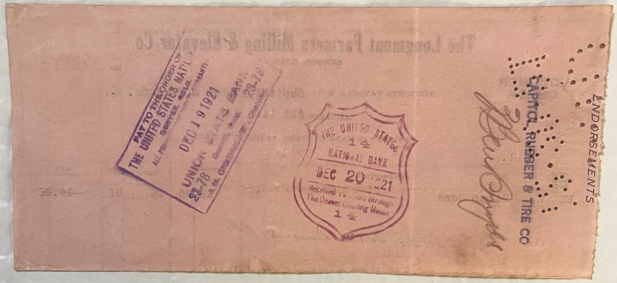 Aged pink voucher check from 1921 with purple stamps and handwritten signatures, showing United States National Bank seal dat