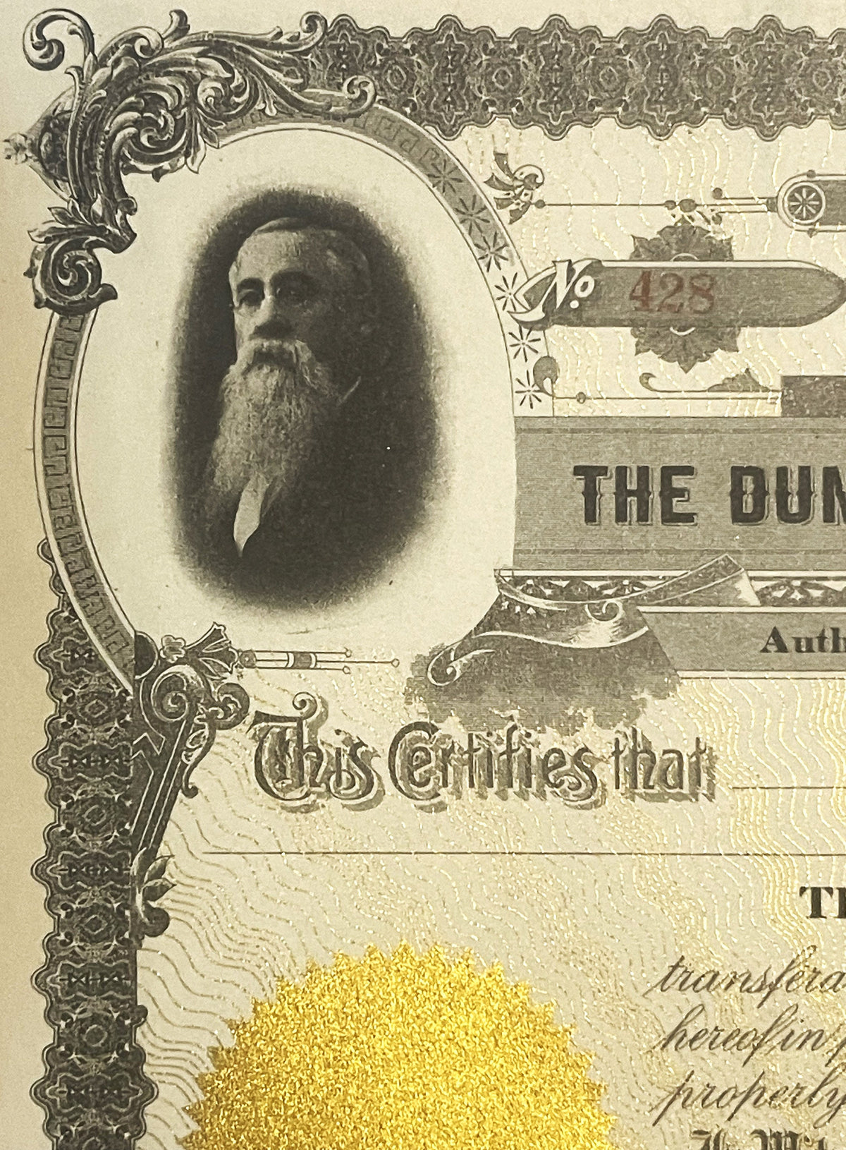 Antique stock certificate featuring bearded man's portrait in ornate oval frame, "The Dun" text visible, gold foil accent at 