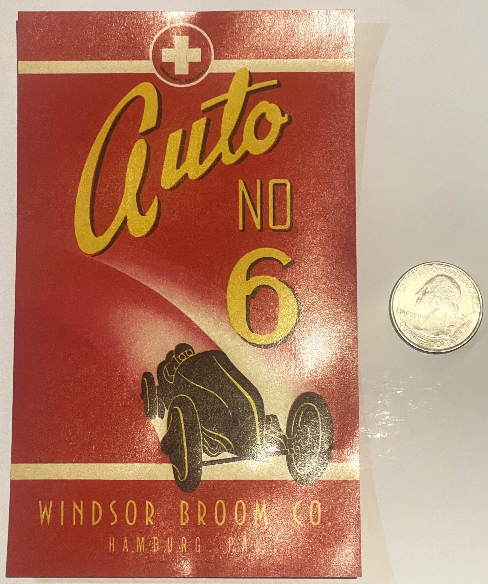 Vintage red broom label with yellow "Auto No 6" text, racing car illustration, and Windsor Broom Co Hamburg PA imprint, shown