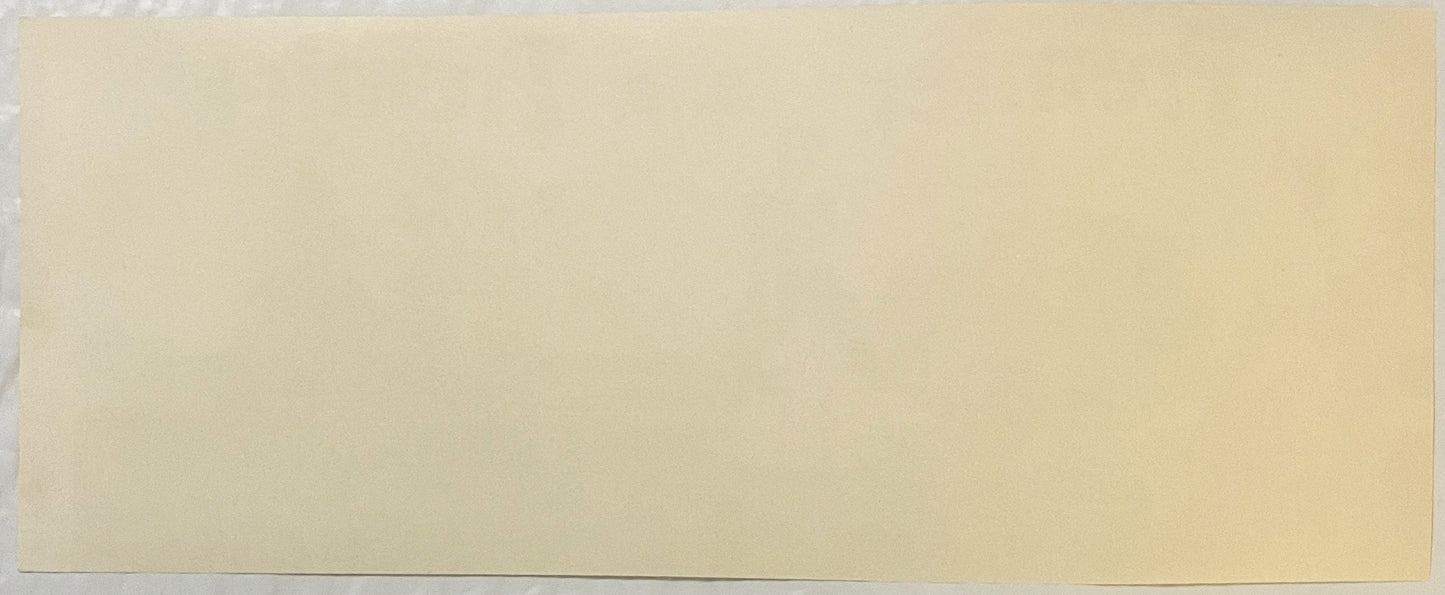 Blank cream-colored vintage label or packaging material with minimal visible text or design elements against plain background