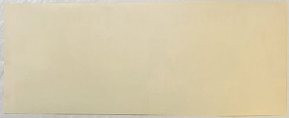 Blank cream-colored vintage label or packaging material with minimal visible text or design elements against plain background